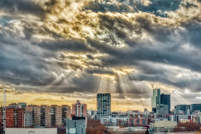 nubes y sol sobre un paisaje urbano